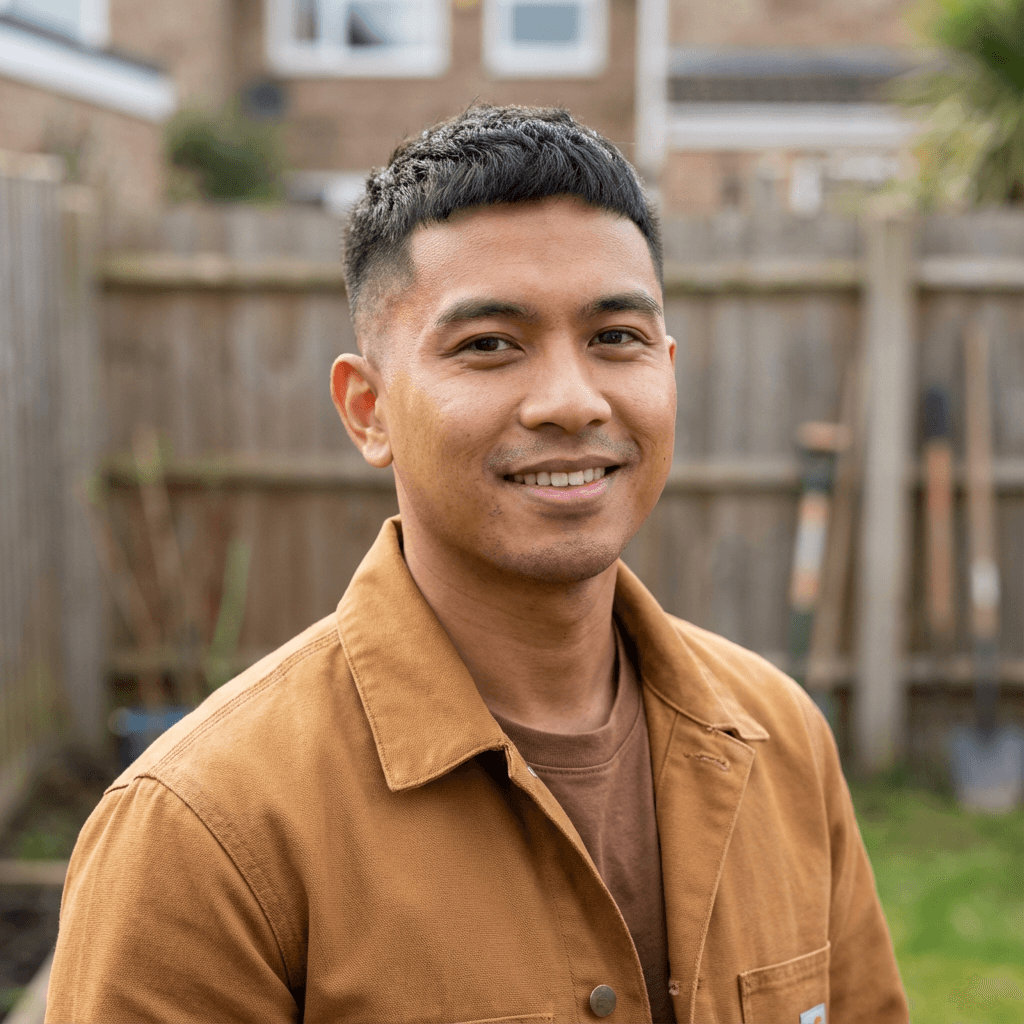 Senior plumber with arms crossed, wearing a work shirt and looking confident